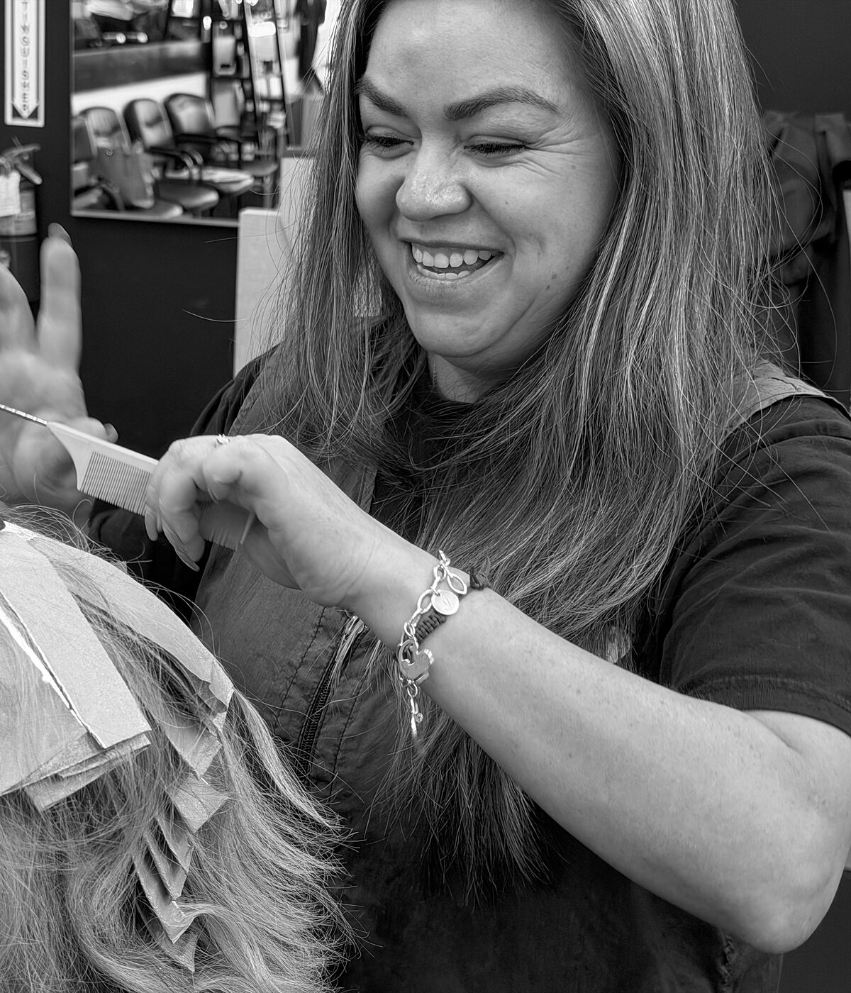 Stylist applying hair color foils at Arturo's Barbershop in Santa Barbara